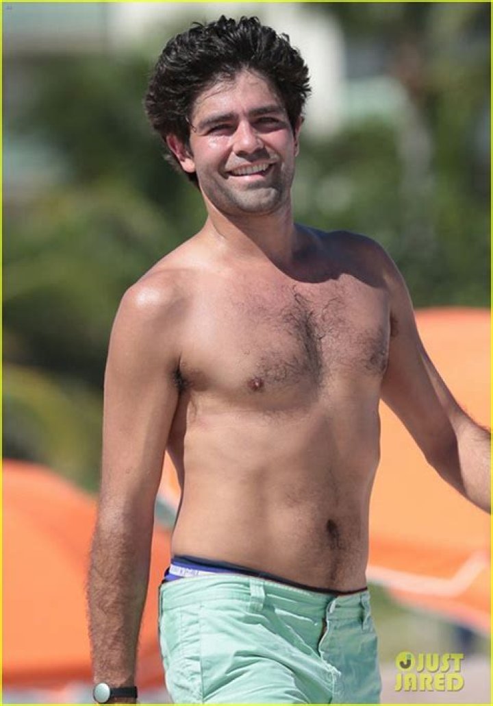 Adrian Grenier goes a shirtless dip while on the beach with his girlfriend in Miami