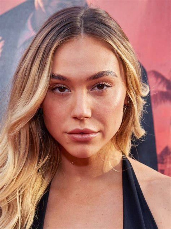 Alexis Ren and her car. Know more about her net worth, properties, wealth, and other assets.