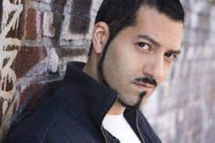Alfredo Narciso wearing black jacket and white vest in inside.