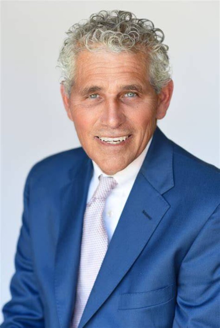 Dr. Kenneth Odinet is wearing a lab coat in the picture.