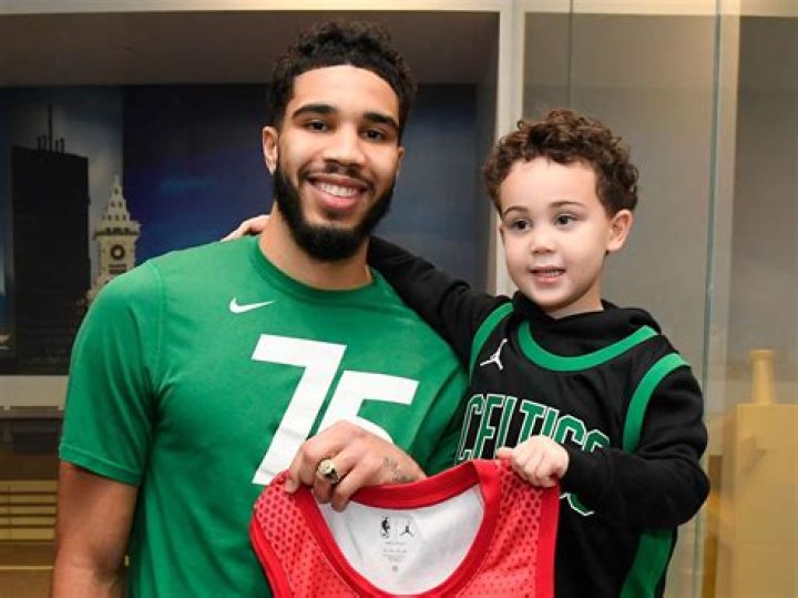 Jayson Christopher Tatum Jr. is sitting under his father's Jayson's lavish car