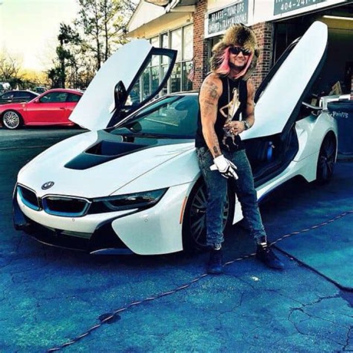 Riff Raff posing with his car (Source: Pinterest)