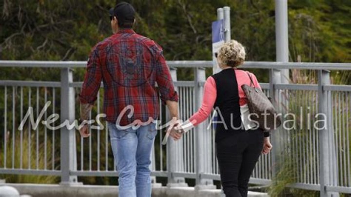 Smith holding hands with his then girlfriend Stella Hudgens.
