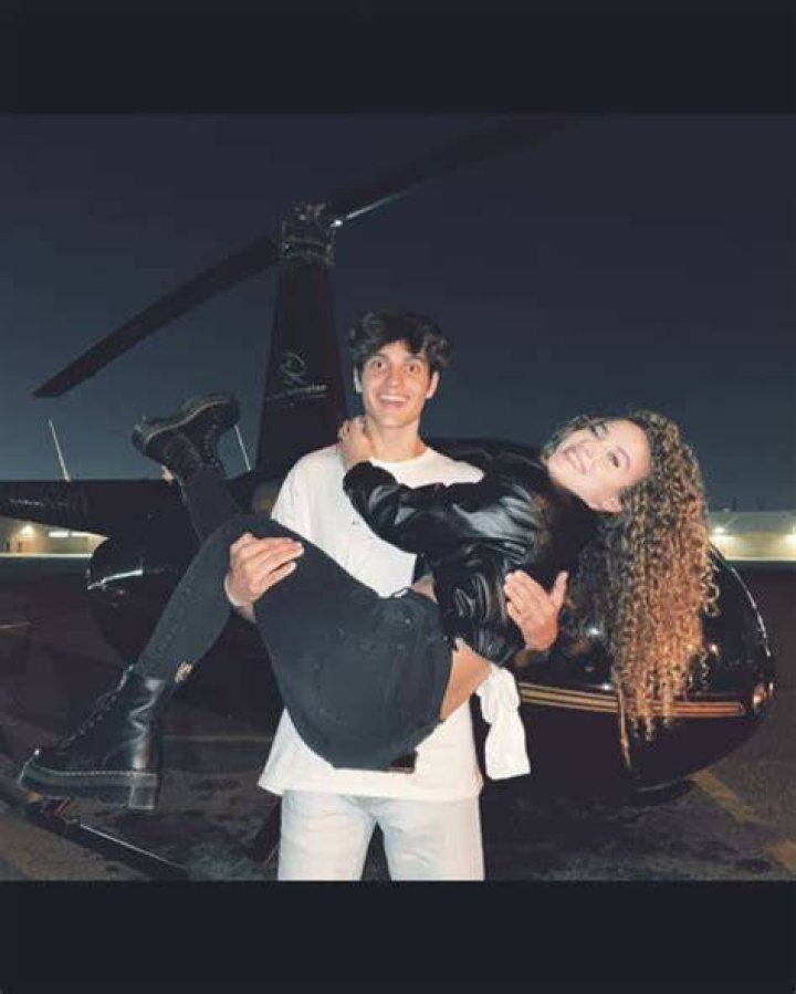 Sofie Dossi grappling boyfriend Dom Brack's face from behind.