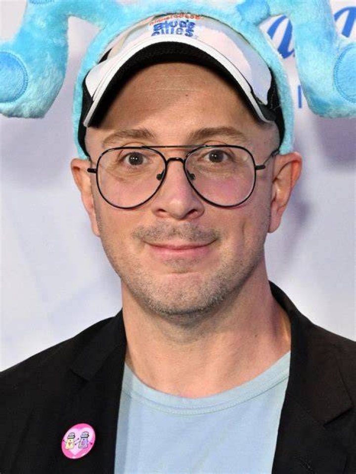 Steve Burns smiling in a woolen hat and the north face jacket.