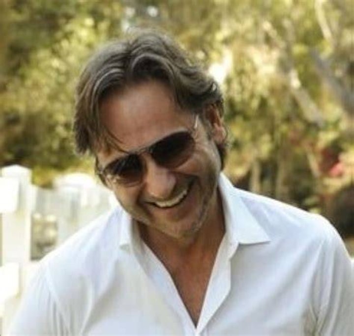 Thomas E. van Dell smiling in a black shirt.